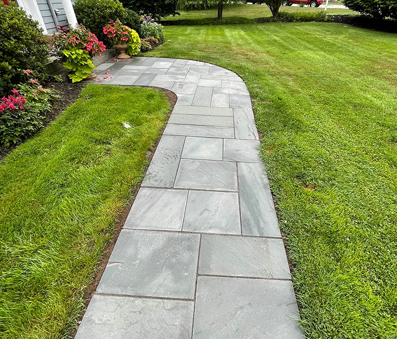 Beautiful entrance to house path made out of natural looking pavers